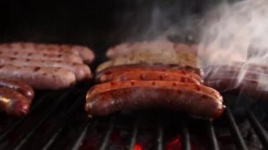 Sausages on grill at BBQ, hot dogs sausage at barbecue