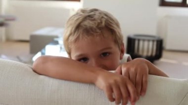 Bored child at home during quarantine. Kid bore with nothing to do during covid