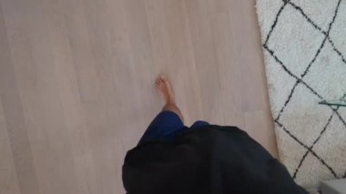 Person POV walking in living room. Man feet point of view at home