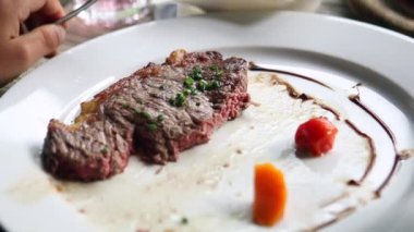 Piece of meat on plate half finished