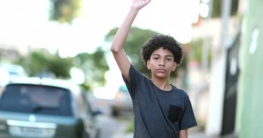 Mixed race kid raising fist in the air political protest