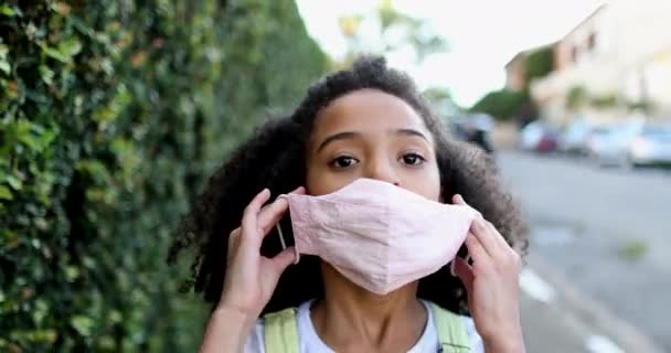 Child Putting Covid Face Mask While Walking Street — Stockvideo