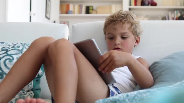 Cute Toddler Boy Watching Content Online Tablet Home Sofa — Vídeo de Stock