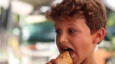 Child eating ice-cream. Young boy eats dessert chocolate ice cream