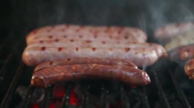 Sausages on grill, traditional hot dogs at barbecue