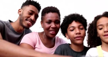 Family gathered together laughing and smiling over social media news