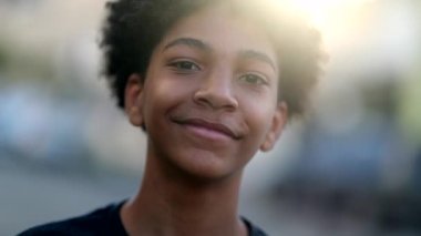 Teen boy of mix race smiling at camera. Ethnically diverse teenager kid