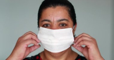 African american black woman removing face mask and smiling to camera