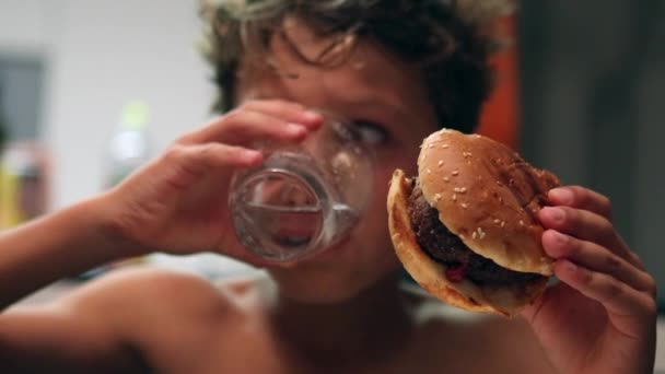 Young Boy Eating Meal Kid Drinking Water Taking Bite Hamburger — ストック動画