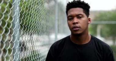 African man staring at camera. Serious black guy walking forward