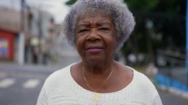 Portrait of a senior 80s Brazilian woman walking outside in street