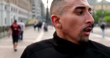 Hispanic man taking a deep breath. Latin person feeling relief and satisfaction