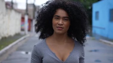 One young woman walking forward in street a confident black person