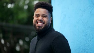 Gülen ve gülümseyen genç bir zenci Latin bir Brezilyalı 'nın yüzünü kameraya çeviriyor.