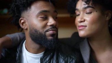 A young black couple kissing