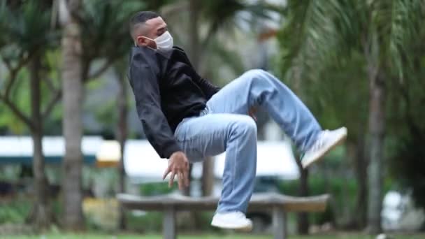 Young Man Doing Back Flip Wearing Face Mask Dancing — Stockvideo