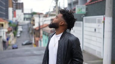 One young black man looking at sky contemplating life thinking
