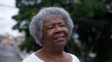 Portrait of an older woman face looking up at sky with HOPE and FAITH