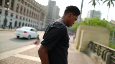 African man dancing in downtown city doing freestyle urban dance