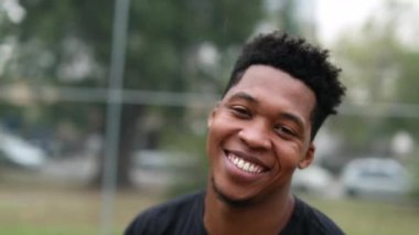 Charismatic happy black man smiling outside