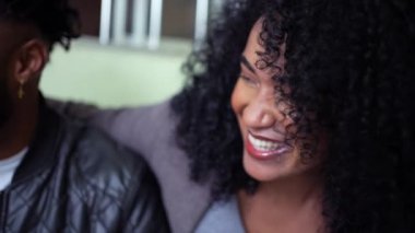 Candid friends hanging out laughing and smiling together at home