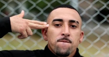 Hispanic man pretending to shoot own head shot with hand