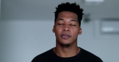 Spontaneous black man burst laughing out loud. African person authentic real life laugh and smile