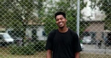 Black man shrugging. Confused African person showing doubt and smiling