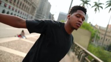 African man dancing in downtown city doing freestyle urban dance