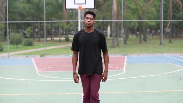 African American Young Man Staring Camera Standing Basketball Court — ストック動画