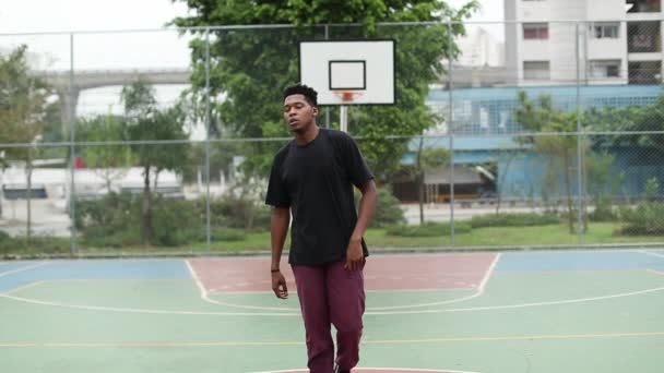 African American Young Man Staring Camera Standing Basketball Court — Stockvideo