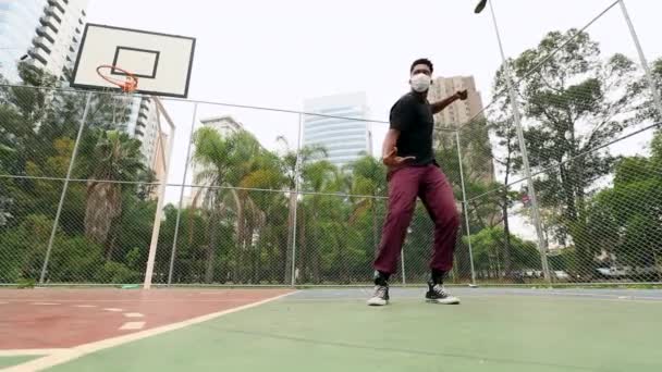 Чорний Чоловік Виконує Міський Танець Баскетбольному Майданчику Хірургічній Масці Обличчя — стокове відео