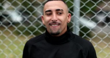 Hispanic latin man pretending to shoot camera with hands and fingers