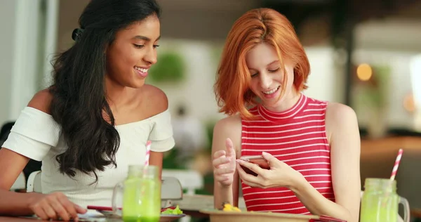 Candid diverse young women taking selfie photo with cellphone