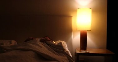 Sleepless Older woman turns light ON suffering from insomnia