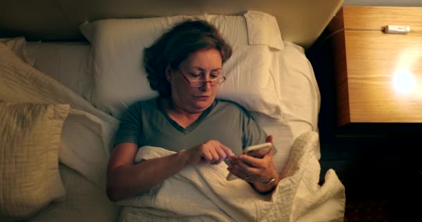 Older Woman Lies Bed Messaging Using Smartphone Device Sleep — Video