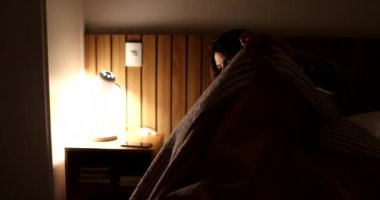 Woman getting out of bed in the night