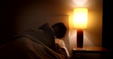 Sleepless Woman getting out of bed in the middle of the night, waking up at dawn