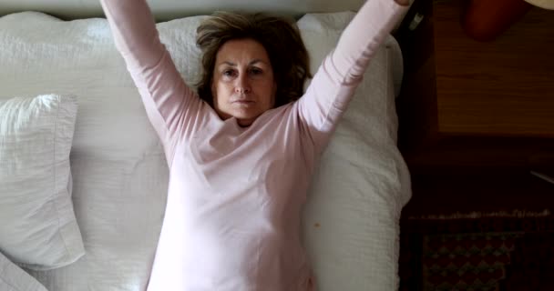 Older Woman Lying Bed Stretching Relaxing — Stockvideo