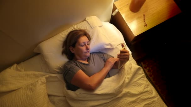 Older Woman Using Cellphone Night Sleep Senior Person Lying Bed — Video