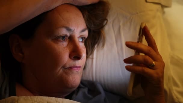 Older Woman Holding Cellphone Bed Looking Screen — Stock videók