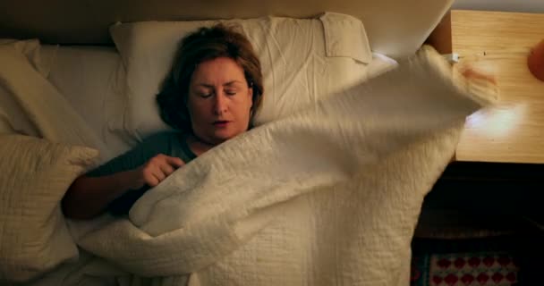 Older Woman Prepares Bed Sleep Person Lays Bed Turns Night — стокове відео
