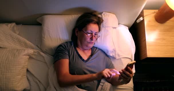 Woman Going Sleep Turns Smartphone Switches Nightstand Bedside Light — Stockvideo