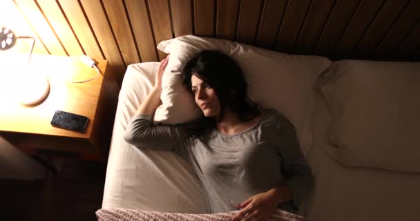 Sleepless Woman Turning Bedside Light Leaning Side Suffering Insomnia — стоковое видео