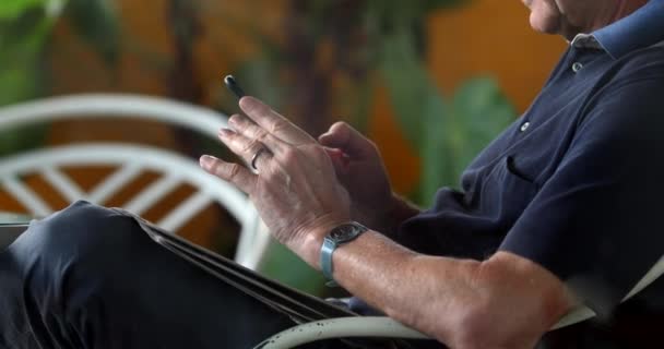 Older Man Using Cellphone Device — Stockvideo