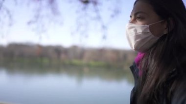 Woman wearing covid-19 face mask walking outside