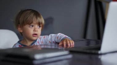 Toddler baby boy watching cartoon in the morning