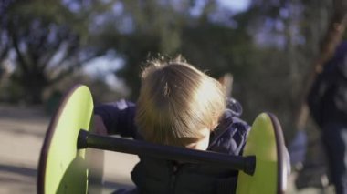 Active little 2 year old toddler playing at playground outside