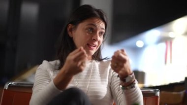 Casual woman in conversation talking among friends explaining concerns