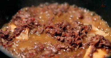 Cooking osso buco meet inside pan. braised veal food close-up